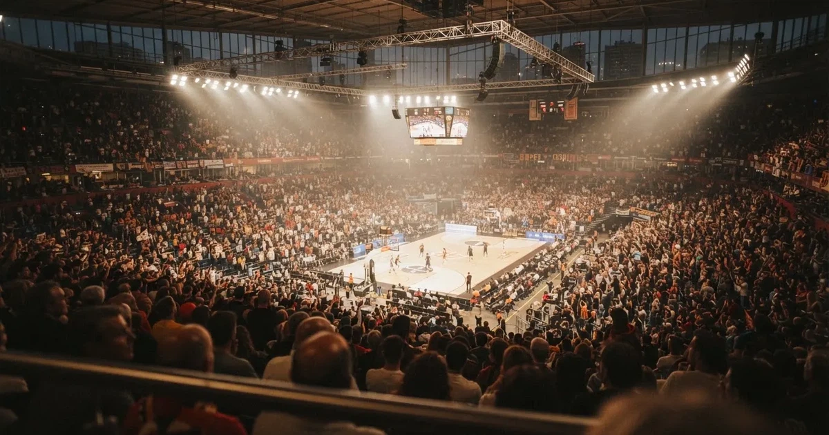 Un pabellón deportivo lleno bajo los focos, fotografiado desde muy lejos