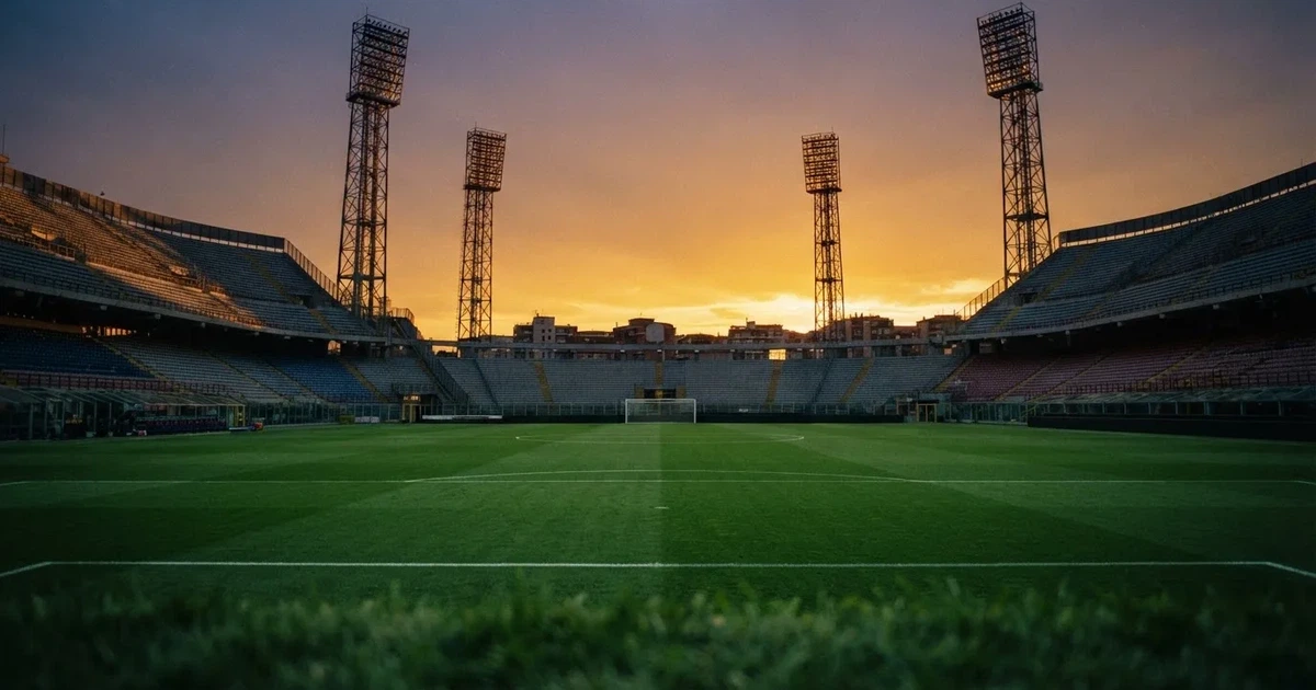 Un estadio de fútbol vacío con torres de iluminación al atardecer